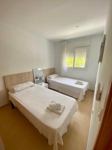 a room with two beds and a window at Condado de Alhama NARANJOS 6 SV08 in El Romero