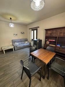 a living room with a table and chairs and a couch at Hostal Restaurante de Montaña Pous de la neu in Alfara de Carles