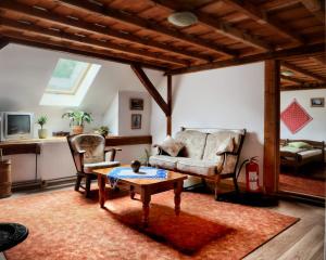 a living room with a couch and a table at Panoráma Panzió Torockó in Rimetea