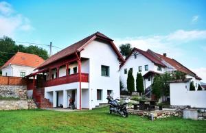 a house with a motorcycle parked in front of it at Panoráma Panzió Torockó in Rimetea