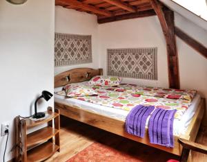 a bedroom with a bed with a wooden headboard at Panoráma Panzió Torockó in Rimetea