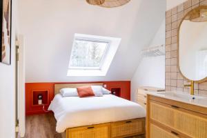 a bedroom with a bed and a sink and a mirror at Duplex calme à Caen - proche Zénith & commerces in Caen