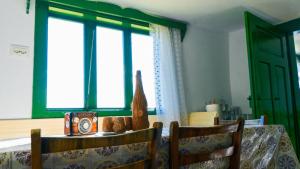 a dining room table with a clock on top of it at La mosu Rovin in Borta