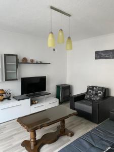 a living room with a couch and a coffee table at Lake City Apartment in Struga