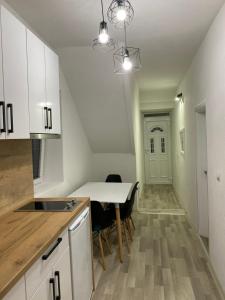 a kitchen and dining room with a table and chairs at Lake City Apartment in Struga +5 photos