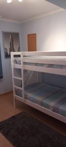 two bunk beds in a room with a rug at Iberflat Villa Tramontana in Benicàssim +26 photos