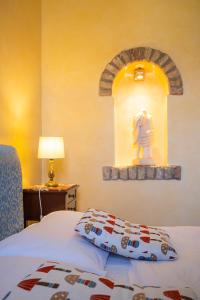 a bedroom with a bed with a statue on a wall at CASA ELSA Charming Apartment in Montebelluna