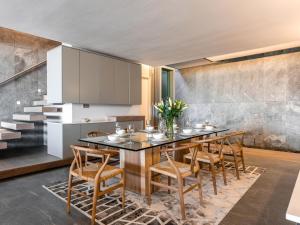 a kitchen with a dining room table and chairs at Beachfront Bliss in Cape Town