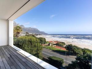 a balcony with a view of the beach at Beachfront Bliss in Cape Town