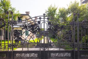 a black wrought iron gate in front of a house at CASA ELSA Charming Apartment in Montebelluna +16 photos