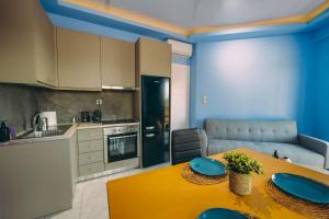 a kitchen with a table with blue plates on it at Ananda Apartments in Skafidia