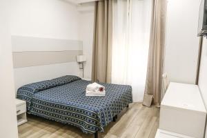 Ένα ή περισσότερα κρεβάτια σε δωμάτιο στο Albergo Athena