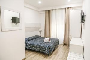 Ένα ή περισσότερα κρεβάτια σε δωμάτιο στο Albergo Athena