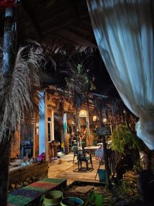 a room with a table and chairs and plants at La finquita de jamgara in Buenaventura