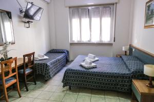 Ένα ή περισσότερα κρεβάτια σε δωμάτιο στο Albergo Athena