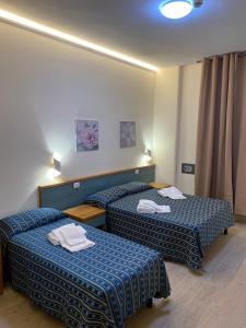 Postel nebo postele na pokoji v ubytování Albergo Athena