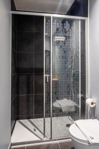 a shower with a glass door in a bathroom at Stay Hotel Lisboa Aeroporto in Lisbon