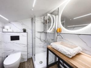 łazienka z prysznicem, toaletą i umywalką w obiekcie Boutique Hotel Pinzgauerhof w Kaprunie