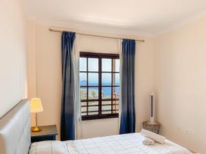 a bedroom with a bed and a window at Seaside apartment with a sea view in Costa Del Silencio +45 photos