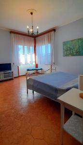 a bedroom with a large bed and a table at Il Corniolo in Tarquinia