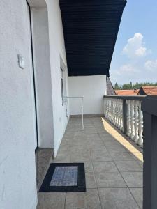 a balcony of a white building with a black roof at Apartman Armin in Sarajevo