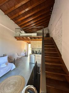 a staircase leading to a room with a kitchen and a kitchenasteryasteryasteryastery at Stenakas Apartments in Chios
