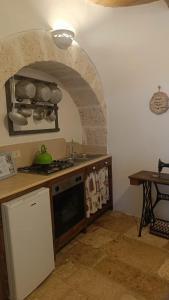Kuchyň nebo kuchyňský kout v ubytování Trulli Soave