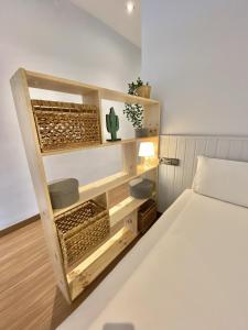 a bedroom with a bed and a shelf with a cactus at Loft Pere IV in Barcelona