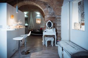 a room with a bed and a vanity with a mirror at Casa Vacanze VENUS in Venosa