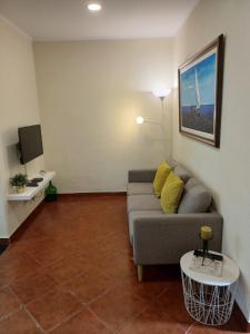 a living room with a couch and a table at Casa do Poço in Quinta do Anjo