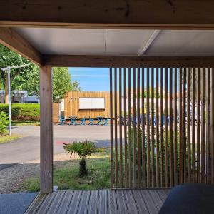 a wooden porch with a sliding door to a basketball court at Mobile home à louer Les Sables d'Olonne - Vendée in La Pironnière