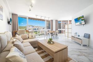 a living room with a couch and a table at Atalaya Beach Apartments Sea View in Finestrat