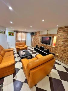 a large living room with couches and a tv at Apartment Sidi Yahia - Residential area - Ideal for Family and Business trip in Hydra