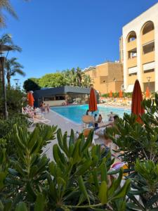 a pool at a resort with people lounging around at Waterfront Gallipoli 150 mt dal mare in Gallipoli