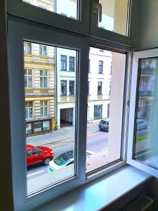 a window with a view of a city street at Power Nap by Harmonia 24h self check-in in Poznań +15 photos