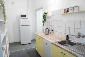 a kitchen with a sink and a refrigerator at Power Nap by Harmonia 24h self check-in in Poznań
