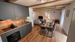 a kitchen and dining room with a table in a room at Nova in Nowa Pasłęka
