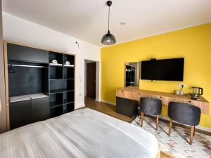 a bedroom with a large bed and a flat screen tv at Grand Apartments Prishtina in Pristina +22 photos