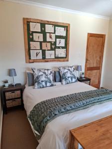 a bedroom with a large white bed with pillows at Meadow View Guest Room in Wakkerstroom