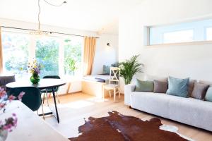a living room with a couch and a table at Exklusives Design-Apartment & Sauna in Warngau