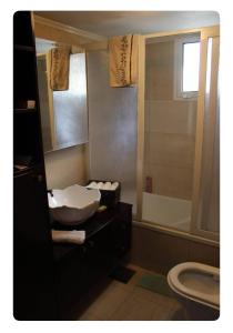 a bathroom with a sink and a toilet and a mirror at Luxury Apartment Koneytra 2 Bedrooms - 2 Baths in Bekfaya