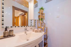 a bathroom with a sink and a mirror at Apartment Masa - FREE bikes in Premantura +7 photos