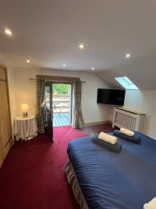 a hotel room with two beds and a television at Stewards Granary in Cornhill-on-tweed +111 photos