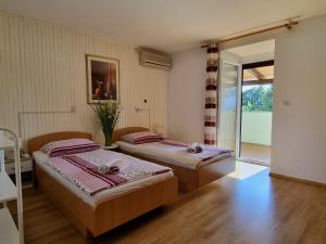 Postel nebo postele na pokoji v ubytování Apartment Melanie