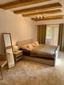 a bedroom with a bed and a ladder and a window at Dream House - Vysoké Tatry in Vysoké Tatry