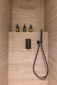 three bottles of alcohol sitting on a shelf in a bathroom at Quartier Libre Opera in Paris