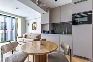a kitchen and living room with a table and chairs at Quartier Libre Opera in Paris