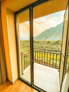 a room with a window with a view at Hotel Gold Kazbegi in Stepantsminda