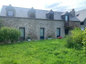 an old stone house with a green yard at Charme St Malo in Saint Malo