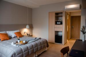 a bedroom with a bed with a tray on it at Gran Hotel Dakar in Mendoza